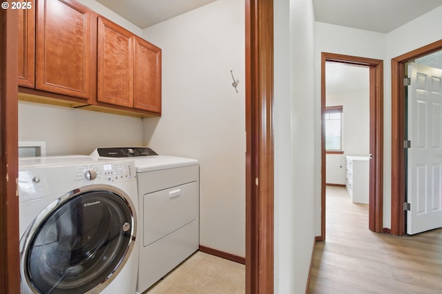 1146 SE Millright Ave, Mcminnville, OR 97128 - laundry area featuring washer and clothes dryer, cabinet space, baseboards, and light wood-style flooring