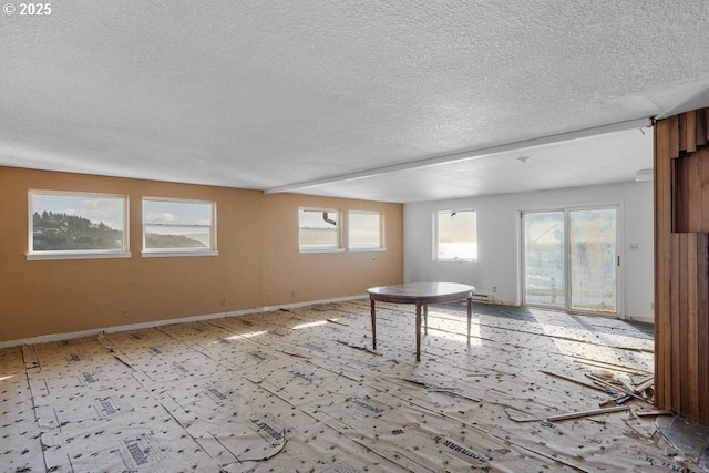 unfurnished room featuring a textured ceiling