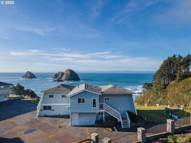 exterior space featuring a water view and a garage