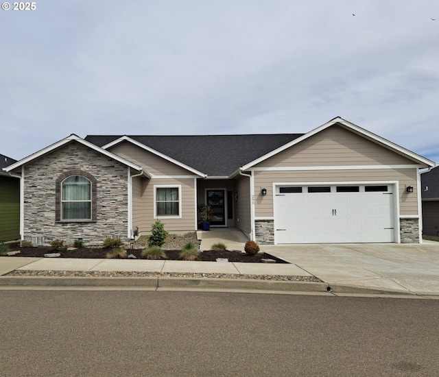 view of front of house featuring a shingled roof, stone siding, driveway, and an attached garage