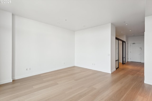 949 NW Overton St Unit 1007, Portland, OR 97209 - empty room with light wood-style floors, baseboards, and recessed lighting
