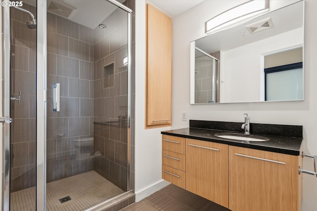949 NW Overton St Unit 1007, Portland, OR 97209 - bathroom featuring a shower stall, vanity, and tile patterned floors