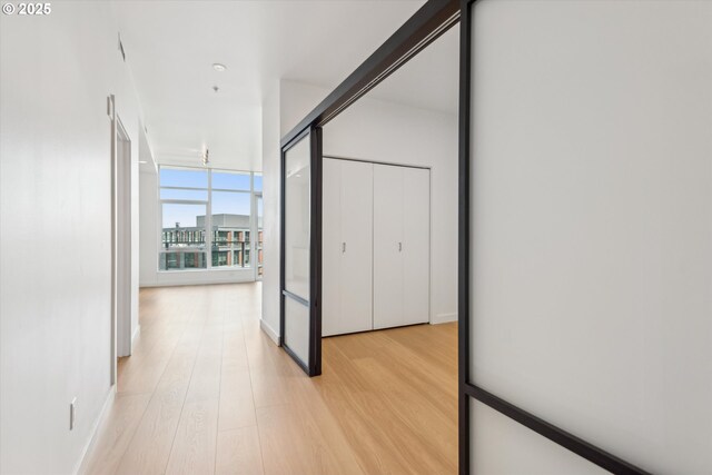 949 NW Overton St Unit 1007, Portland, OR 97209 - hall featuring light wood-style floors and expansive windows