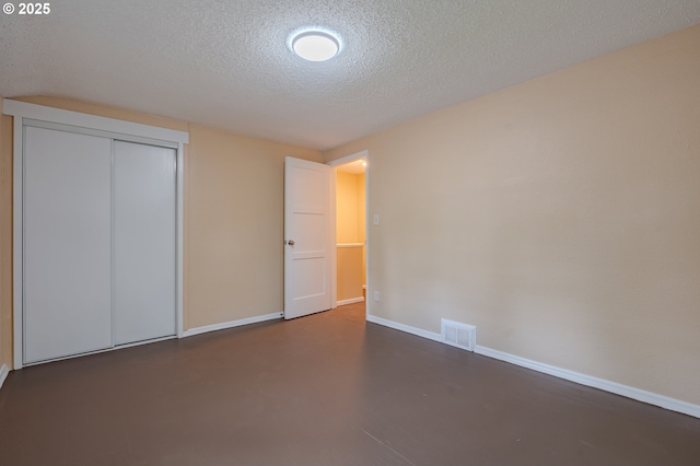 3211 E 17th St, Vancouver, WA 98661 - unfurnished bedroom with a textured ceiling, finished concrete floors, and a closet