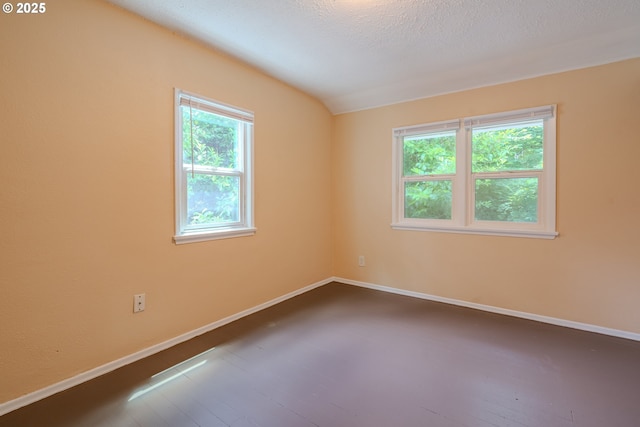 3211 E 17th St, Vancouver, WA 98661 - empty room featuring dark wood-style flooring, lofted ceiling, and a textured ceiling