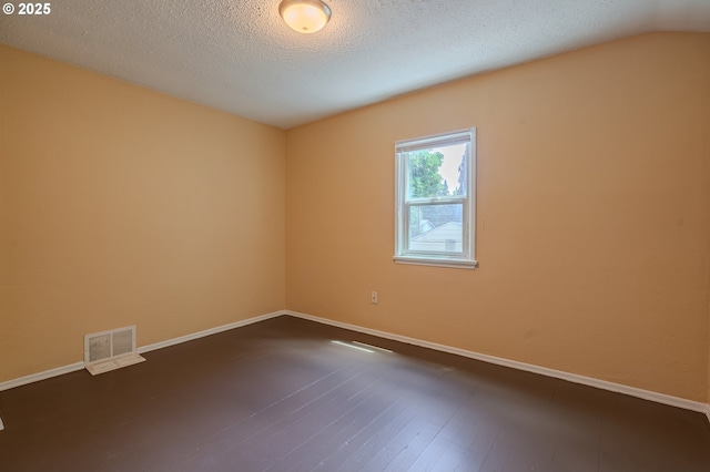 3211 E 17th St, Vancouver, WA 98661 - spare room with a textured ceiling, dark wood-style floors, and vaulted ceiling