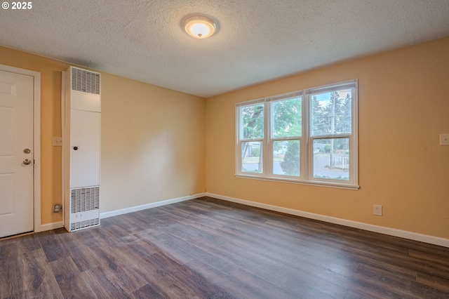 3211 E 17th St, Vancouver, WA 98661 - unfurnished room featuring a heating unit, dark wood finished floors, and a textured ceiling
