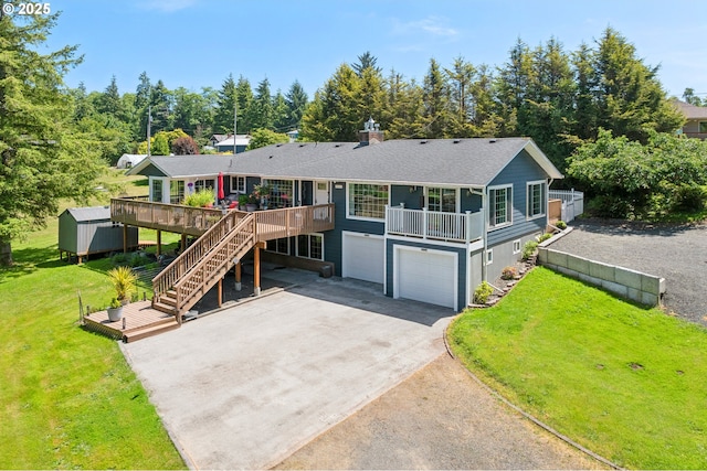 35111 Jefferson Ln, Astoria, OR 97103 - view of front of home with an attached garage, a storage unit, driveway, a wooden deck, and a front lawn