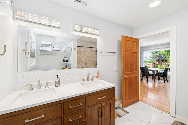 35111 Jefferson Ln, Astoria, OR 97103 - full bathroom featuring marble finish floors, double vanity, and a shower