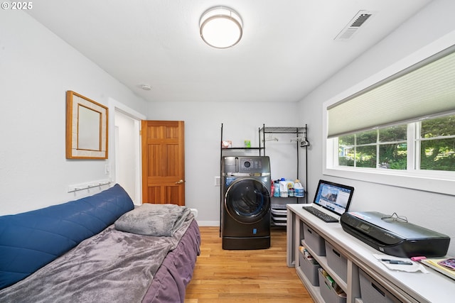 35111 Jefferson Ln, Astoria, OR 97103 - bedroom featuring light wood-style floors and stacked washer / dryer