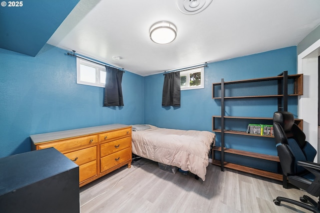 35111 Jefferson Ln, Astoria, OR 97103 - bedroom featuring light wood-type flooring, multiple windows, and an office area