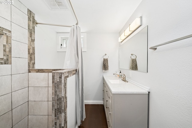 35111 Jefferson Ln, Astoria, OR 97103 - full bathroom featuring vanity, a tile shower, and wood finished floors