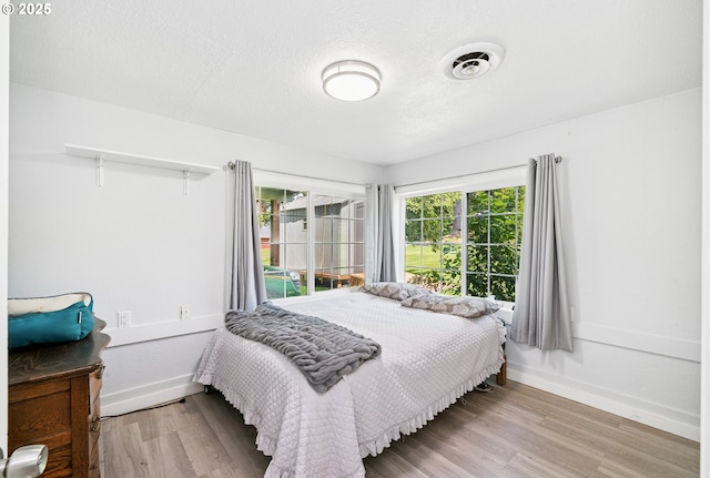 35111 Jefferson Ln, Astoria, OR 97103 - bedroom featuring wood finished floors and a textured ceiling