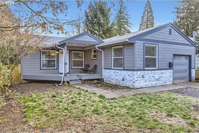 single story home with a garage and covered porch