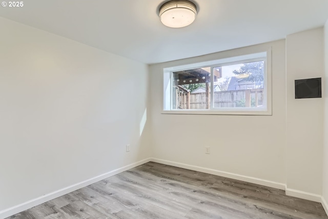 spare room featuring wood-type flooring