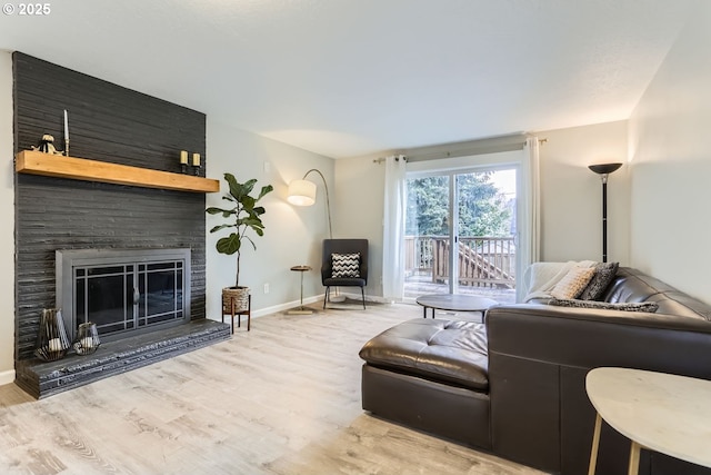 living room with a fireplace and light hardwood / wood-style floors