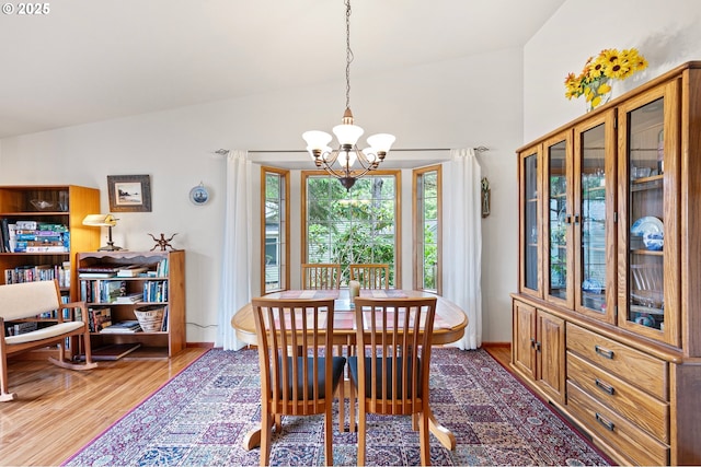 20 Wild Winds St, Florence, OR 97439 - dining space featuring a chandelier, wood finished floors, and high vaulted ceiling