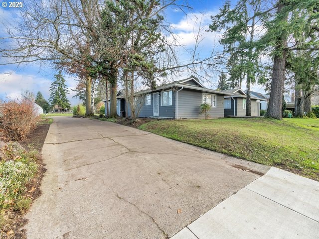 view of side of home with a yard