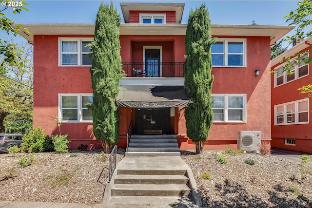 1534 NE 26th Ave Unit 8, Portland, OR 97232 - view of front of house with a cooling unit, stucco siding, and a balcony