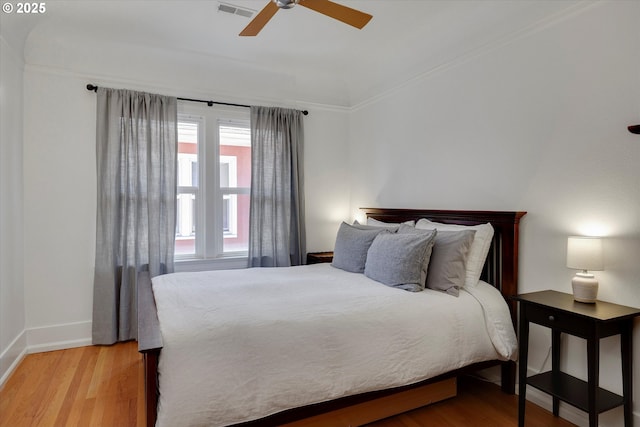 1534 NE 26th Ave Unit 8, Portland, OR 97232 - bedroom with light wood-style floors, baseboards, ceiling fan, and ornamental molding