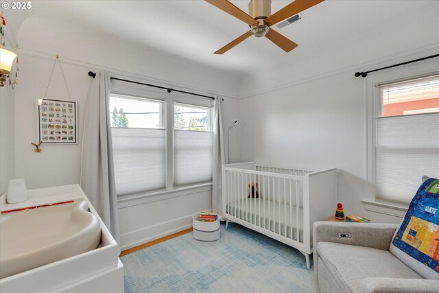 1534 NE 26th Ave Unit 8, Portland, OR 97232 - bedroom featuring a crib, ceiling fan, wood finished floors, and a sink