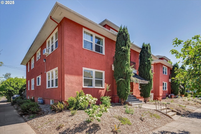 1534 NE 26th Ave Unit 8, Portland, OR 97232 - view of front of home featuring stucco siding and cooling unit