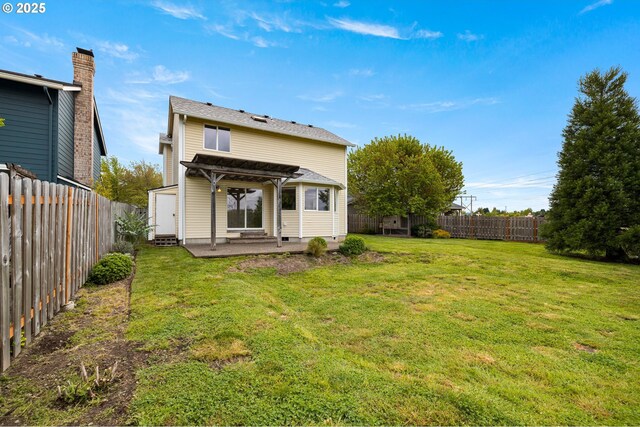 back of house featuring a lawn, a fenced backyard, a patio area, and a pergola