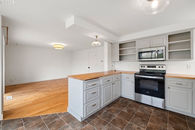 kitchen with open shelves, stainless steel appliances, a peninsula, and butcher block counters