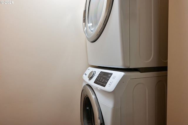 washroom featuring stacked washer / dryer