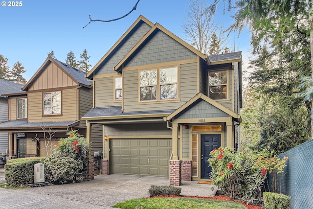 craftsman inspired home with a garage, brick siding, concrete driveway, and fence