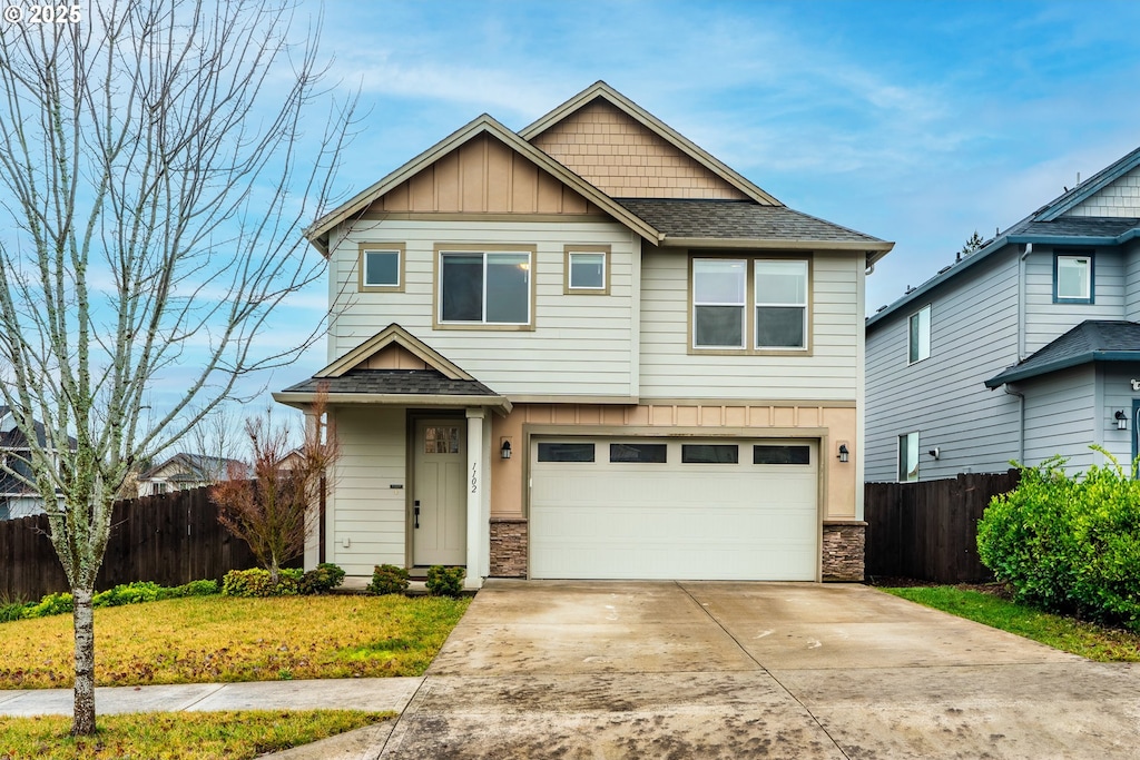 craftsman-style home with a front yard and a garage