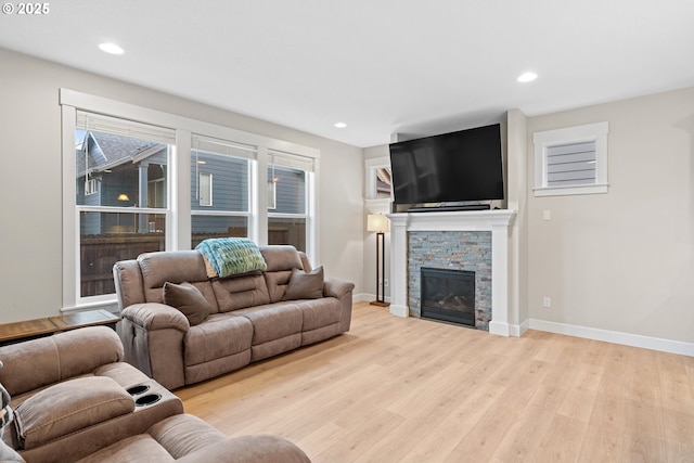 living room with a fireplace and light hardwood / wood-style floors