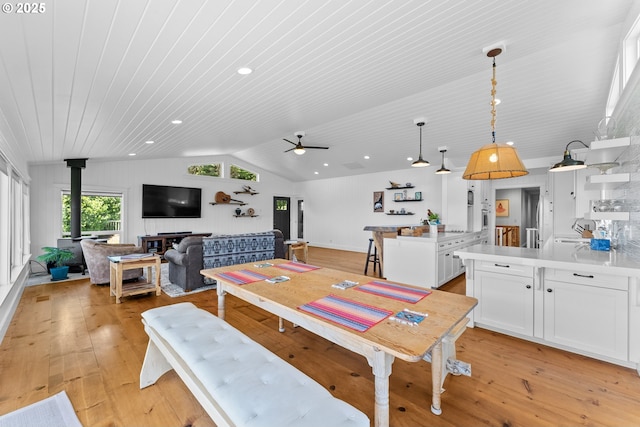 15436 Oceanview Dr, Brookings, OR 97415 - dining room with wood ceiling, a ceiling fan, light wood-type flooring, a wood stove, and lofted ceiling