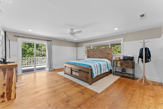 15436 Oceanview Dr, Brookings, OR 97415 - bedroom with light wood finished floors, a decorative wall, multiple windows, and access to exterior