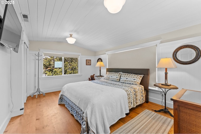 15436 Oceanview Dr, Brookings, OR 97415 - bedroom with vaulted ceiling, baseboards, visible vents, and wood finished floors