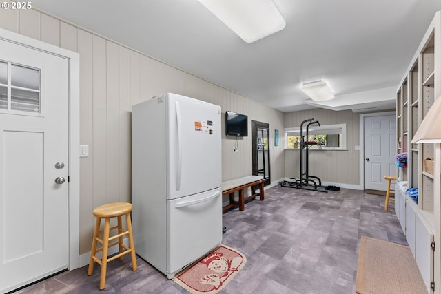 15436 Oceanview Dr, Brookings, OR 97415 - interior space featuring freestanding refrigerator, wooden walls, and baseboards