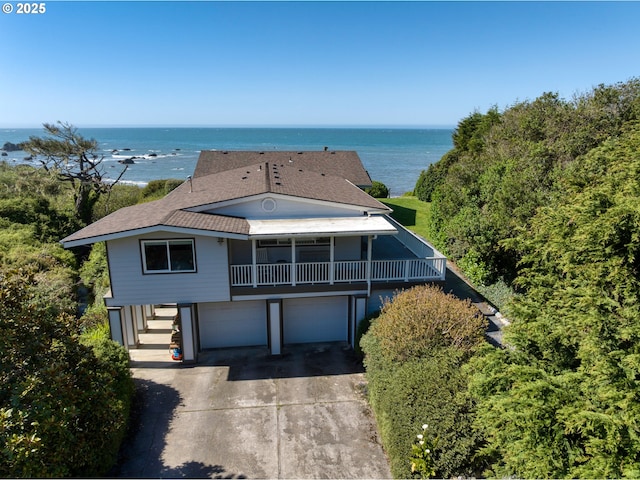 15436 Oceanview Dr, Brookings, OR 97415 - view of front facade with an attached garage, a water view, driveway, and stairs