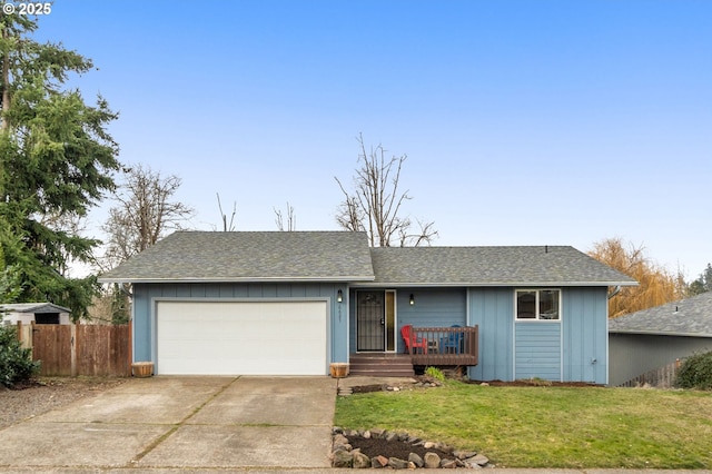 ranch-style home with a garage and a front lawn