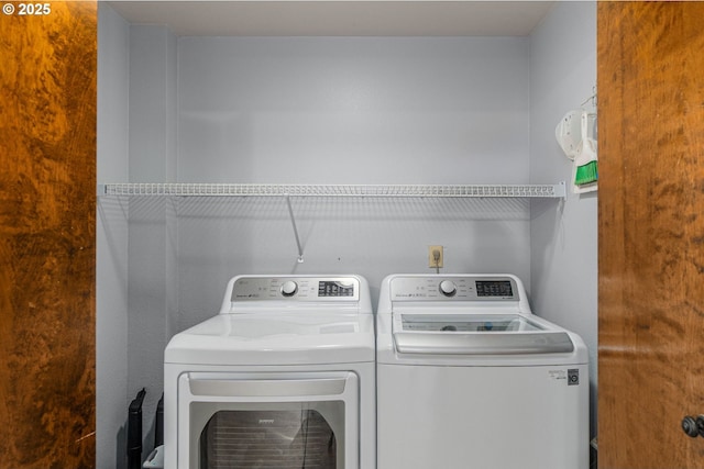 clothes washing area with washer and dryer