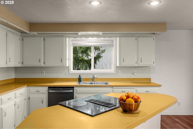 kitchen with sink, black appliances, a textured ceiling, hardwood / wood-style floors, and white cabinets