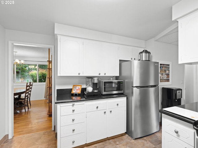 2700 SW 175th Ave, Beaverton, OR 97003 - kitchen with appliances with stainless steel finishes, white cabinets, dark countertops, and a chandelier