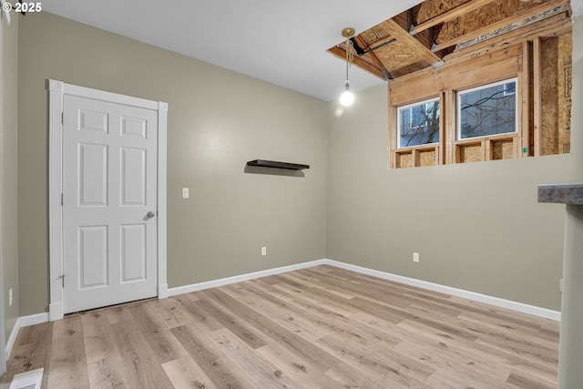 spare room with light hardwood / wood-style flooring