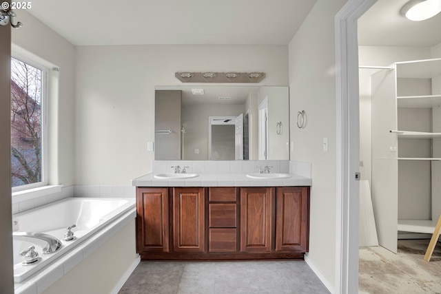 bathroom with a bathing tub and vanity