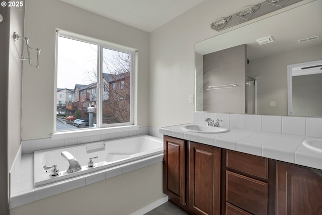 bathroom featuring vanity and a tub