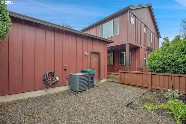 rear view of house featuring cooling unit