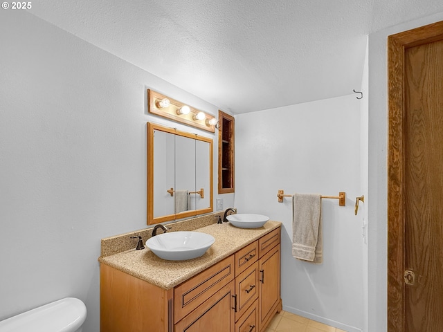 55 Irving St, Cathlamet, WA 98612 - bathroom featuring double vanity, a textured ceiling, and tile patterned floors