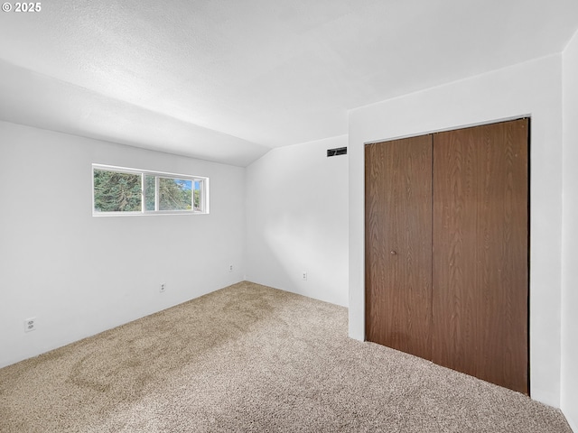55 Irving St, Cathlamet, WA 98612 - unfurnished bedroom featuring carpet, a closet, and vaulted ceiling