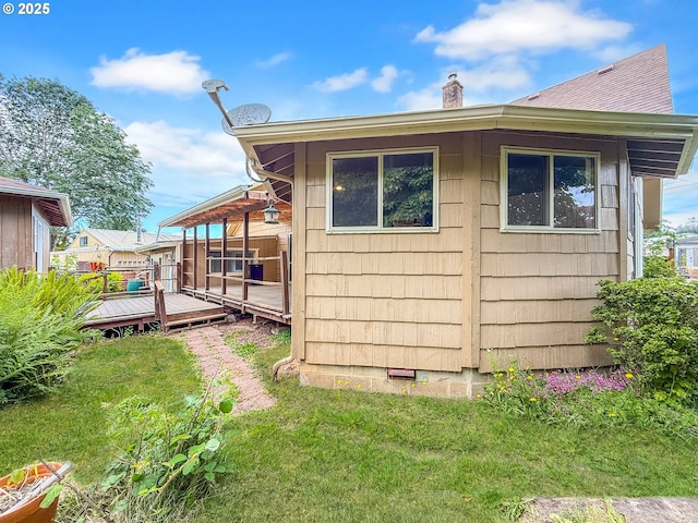 55 Irving St, Cathlamet, WA 98612 - view of side of home with a chimney, a wooden deck, and a yard