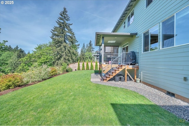 back of property with a lawn, stairway, crawl space, and a deck