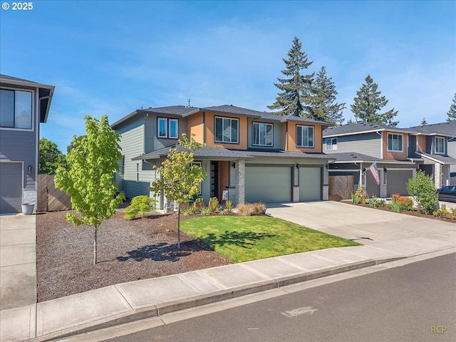 prairie-style home with an attached garage, concrete driveway, and a shingled roof